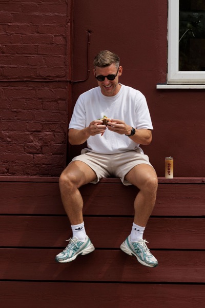 A customer eating outside the Junto cafe — photo 236