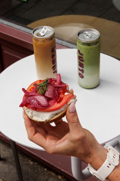 A customer eating outside the Junto cafe — photo 256