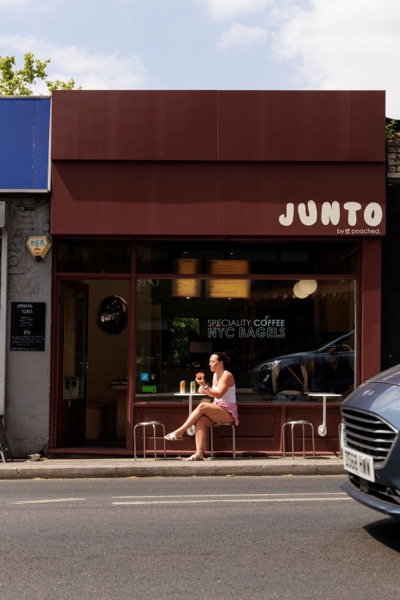 A customer eating outside the Junto cafe — photo 258