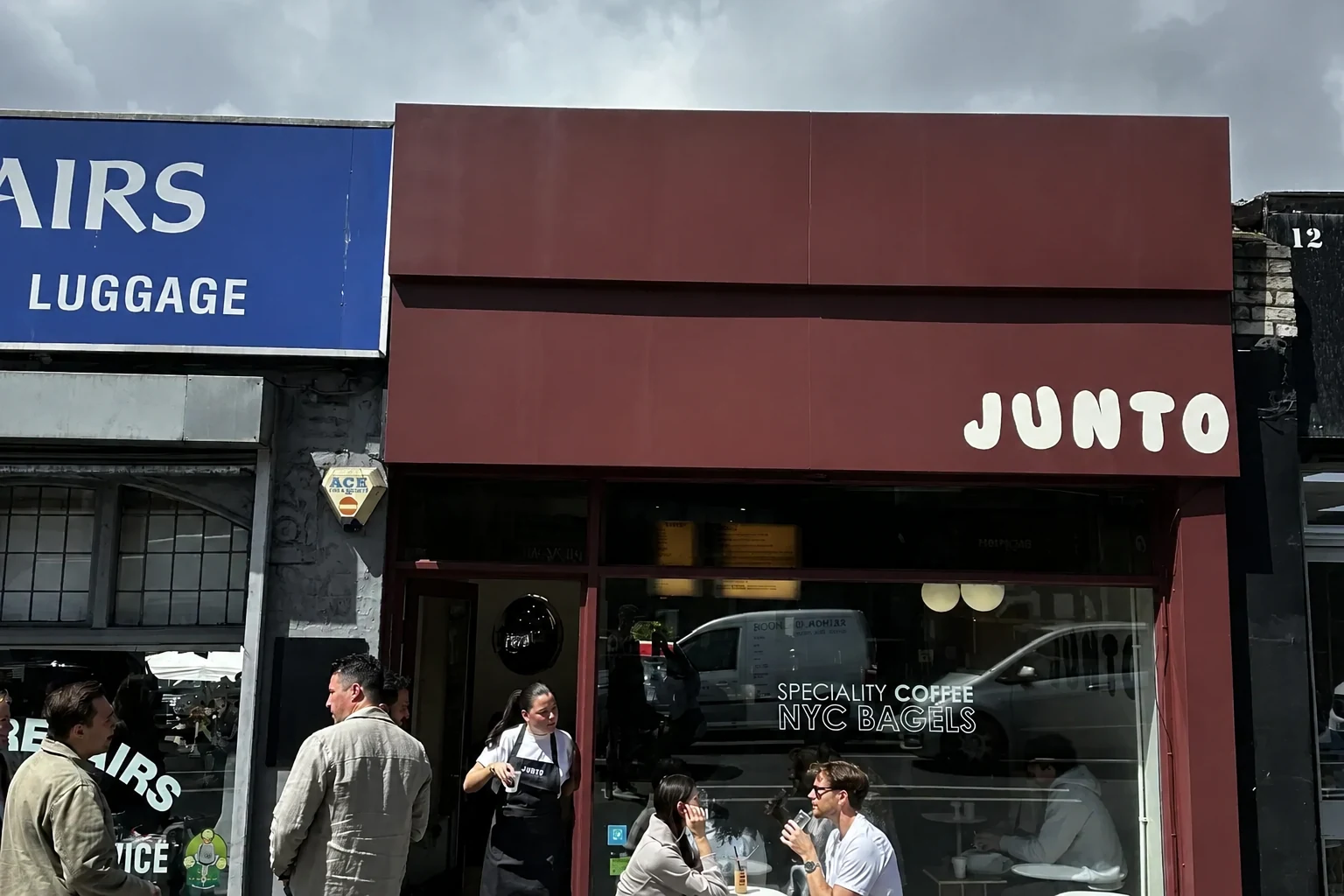 The Junto by Poached storefront on Beckenham High Street with the JUNTO wordmark above the window.